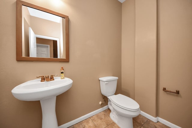 bathroom featuring tile patterned flooring and toilet