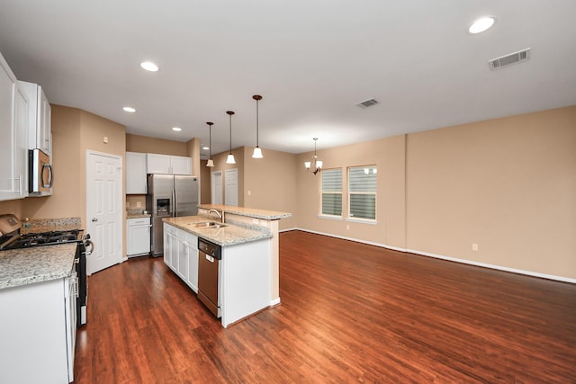 kitchen with sink, stainless steel appliances, an island with sink, decorative light fixtures, and white cabinets