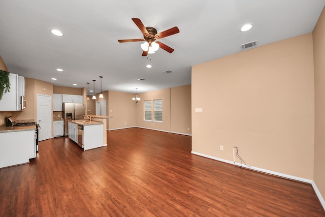 kitchen featuring ceiling fan with notable chandelier, stainless steel appliances, a center island, white cabinetry, and hanging light fixtures