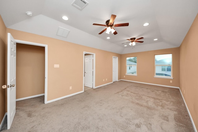 interior space with ceiling fan, light colored carpet, and lofted ceiling