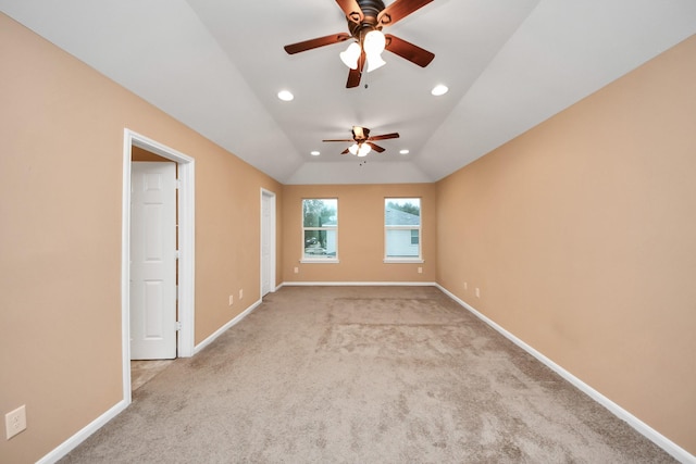 carpeted spare room featuring ceiling fan and lofted ceiling