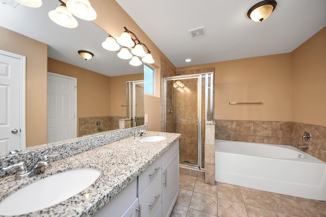 bathroom with tile patterned floors, vanity, and shower with separate bathtub