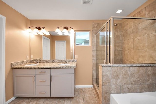 bathroom with tile patterned floors, vanity, and separate shower and tub