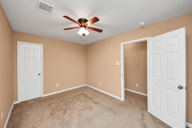 empty room with ceiling fan and light carpet