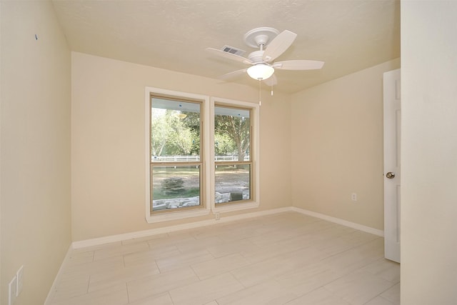 unfurnished room with ceiling fan