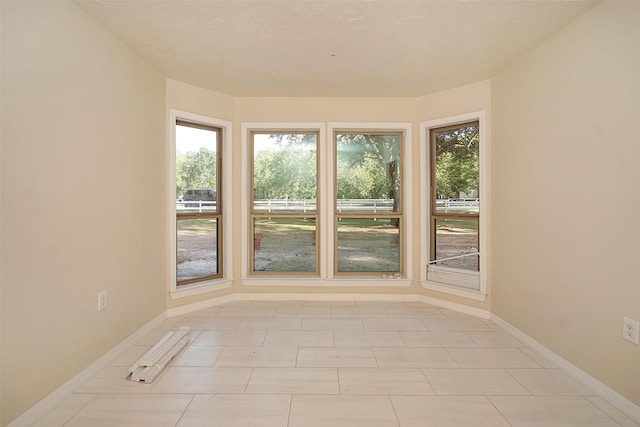 empty room with light tile patterned floors