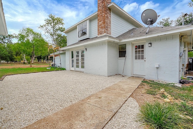 rear view of property with french doors