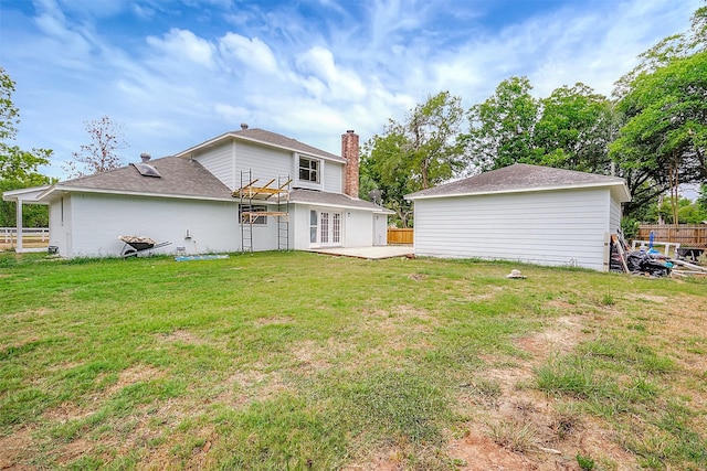 back of property featuring a lawn and a patio area