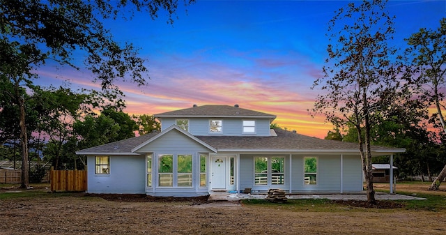 view of back house at dusk