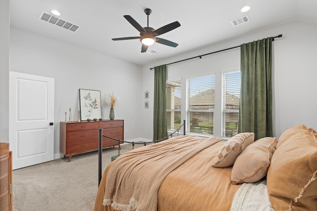 bedroom featuring ceiling fan, vaulted ceiling, and light colored carpet