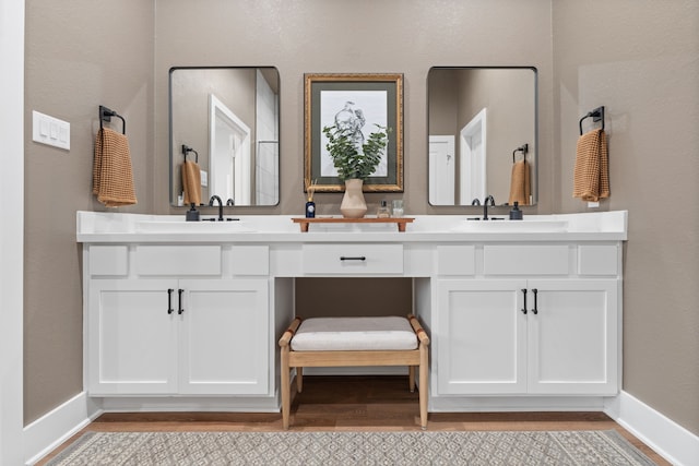 bathroom featuring vanity and hardwood / wood-style floors