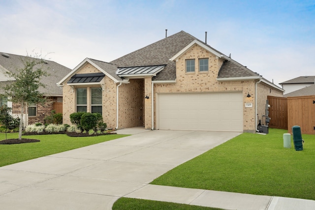 view of front of home featuring a front lawn and a garage