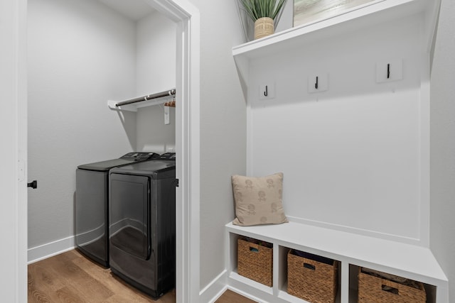 interior space with washing machine and clothes dryer and hardwood / wood-style flooring