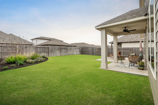 view of yard with ceiling fan and a patio