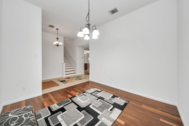 interior space with a notable chandelier and wood-type flooring