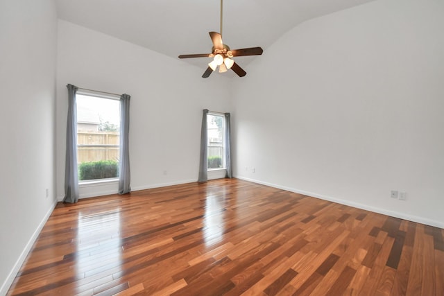 empty room featuring lofted ceiling, wood-type flooring, and ceiling fan