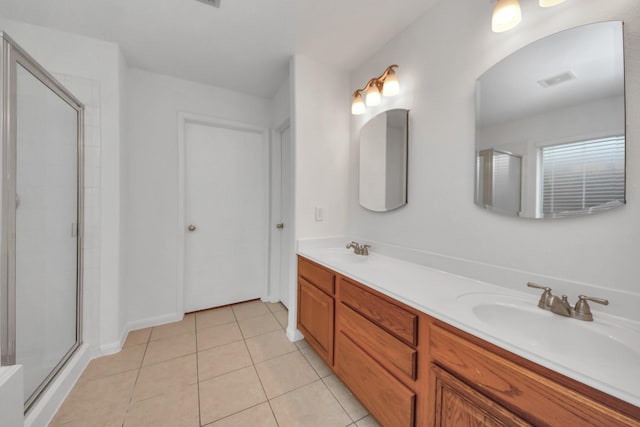 bathroom with tile patterned floors, a shower with shower door, and vanity