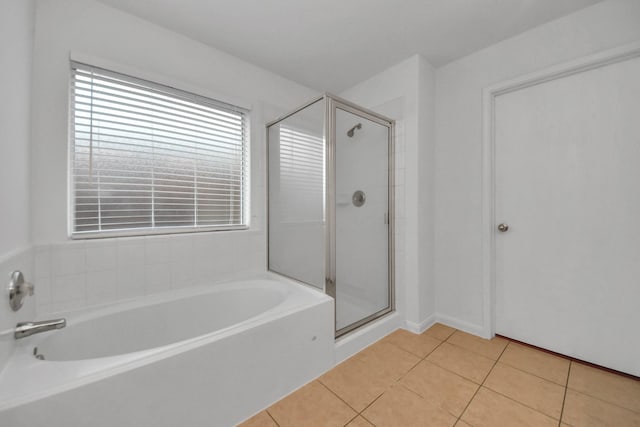 bathroom with plus walk in shower and tile patterned flooring