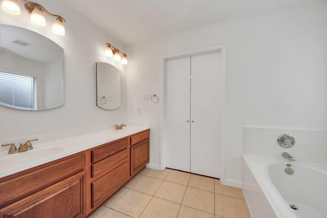 bathroom featuring tile patterned flooring, vanity, and a bathtub