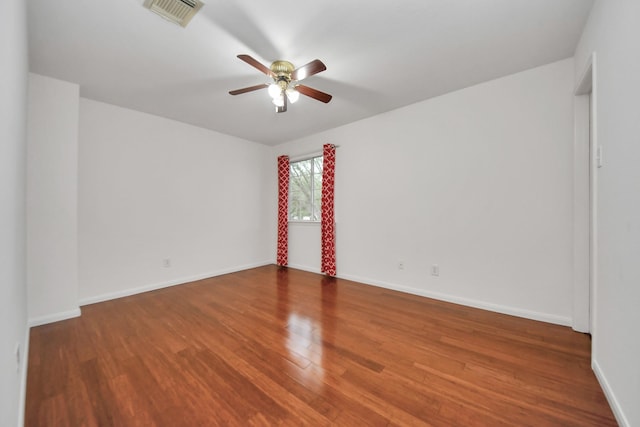 empty room featuring hardwood / wood-style flooring and ceiling fan