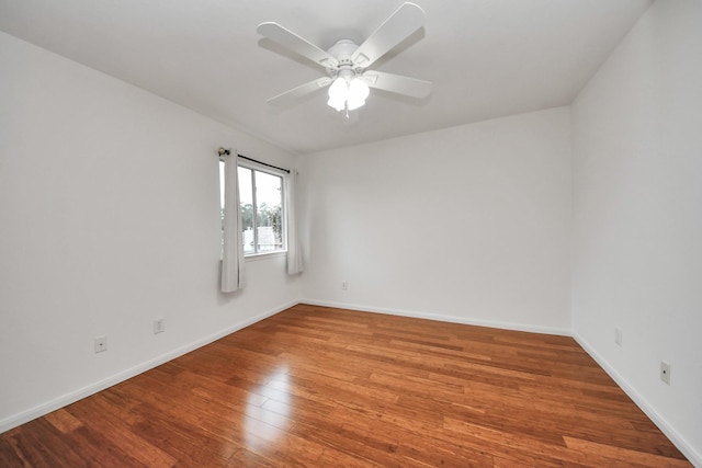 spare room featuring hardwood / wood-style flooring and ceiling fan