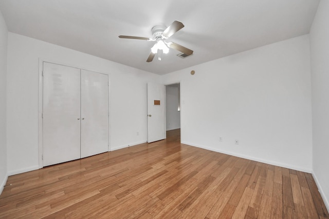 unfurnished bedroom with ceiling fan and light hardwood / wood-style flooring