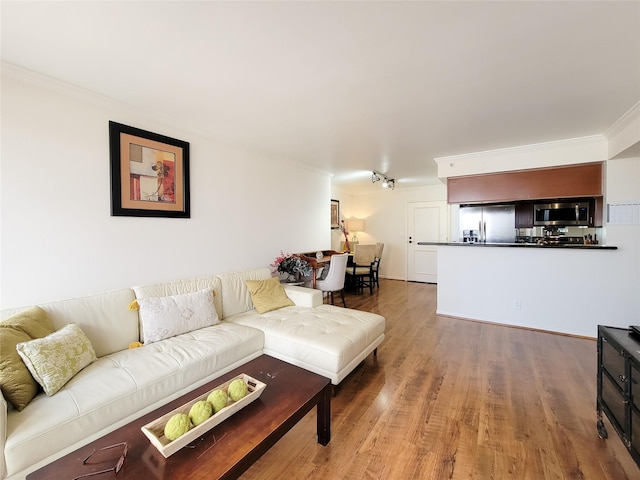 living room featuring hardwood / wood-style floors and ornamental molding