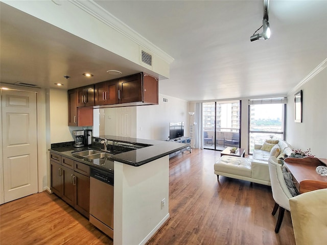 kitchen featuring dishwasher, sink, kitchen peninsula, hardwood / wood-style floors, and ornamental molding