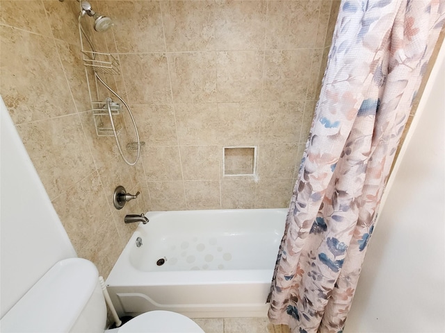 bathroom with tile patterned flooring, shower / tub combo, and toilet