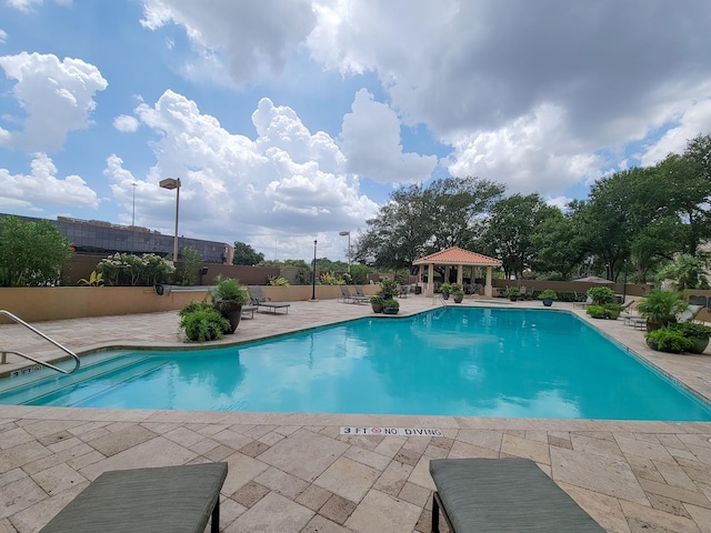 view of swimming pool with a gazebo and a patio area