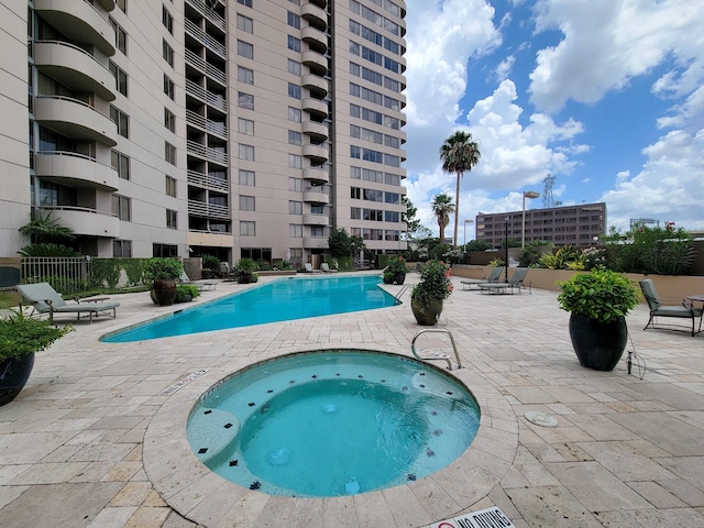 view of swimming pool with a community hot tub and a patio