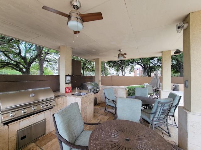 view of patio / terrace with ceiling fan, area for grilling, exterior kitchen, and sink