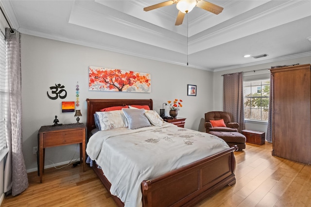 bedroom with a tray ceiling, ceiling fan, and crown molding