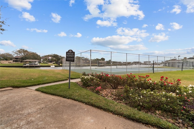 view of community with a lawn and tennis court