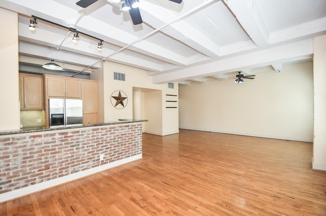 unfurnished living room featuring beamed ceiling, ceiling fan, and light hardwood / wood-style floors