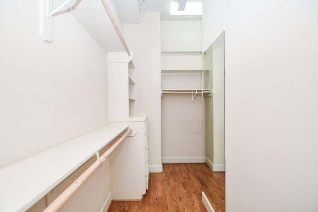 spacious closet with light hardwood / wood-style floors