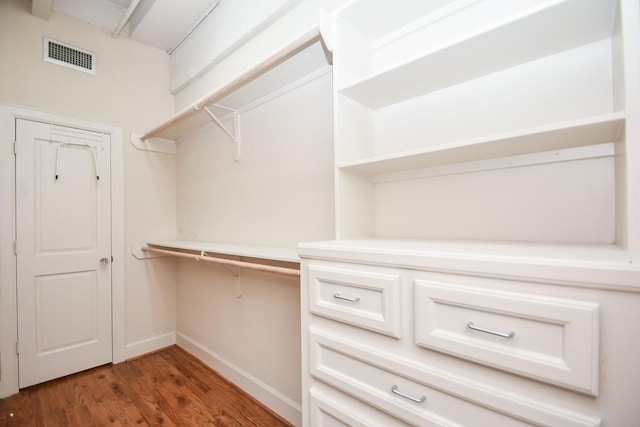 spacious closet with dark hardwood / wood-style floors