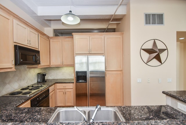 kitchen featuring oven, sink, dark stone countertops, white cooktop, and stainless steel fridge with ice dispenser