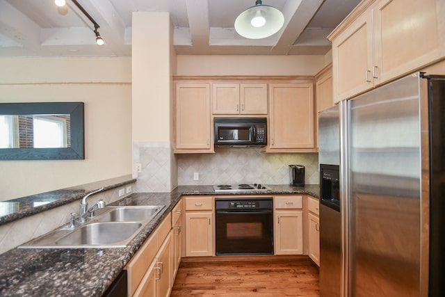 kitchen featuring black appliances, light brown cabinetry, and tasteful backsplash