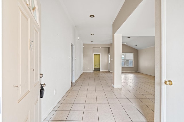 foyer featuring light tile patterned floors and vaulted ceiling