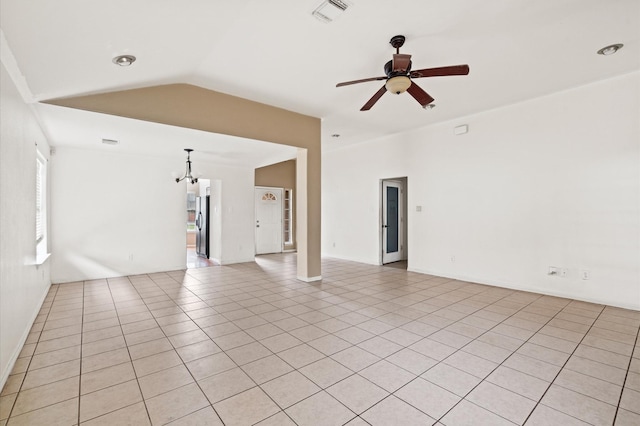 unfurnished living room with ceiling fan with notable chandelier, light tile patterned flooring, and lofted ceiling