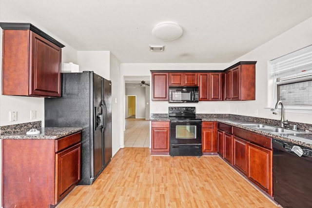 kitchen featuring black appliances, ceiling fan, light hardwood / wood-style floors, and sink