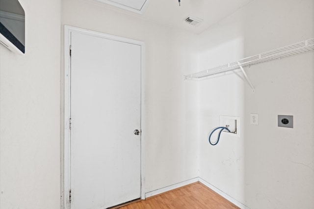 clothes washing area featuring washer hookup, hardwood / wood-style floors, and electric dryer hookup