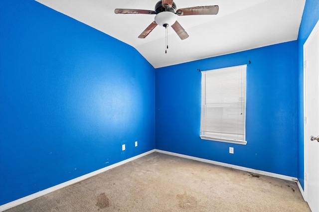 unfurnished room with ceiling fan, carpet floors, and vaulted ceiling