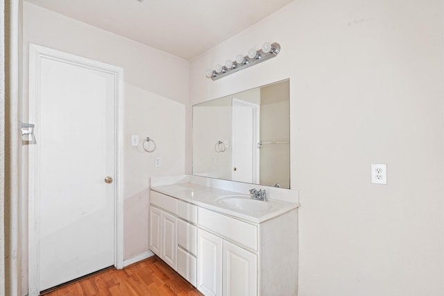 bathroom featuring hardwood / wood-style flooring and vanity