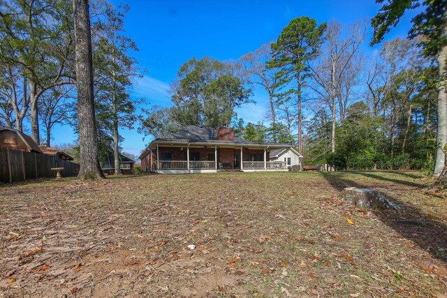 rear view of house featuring a sunroom