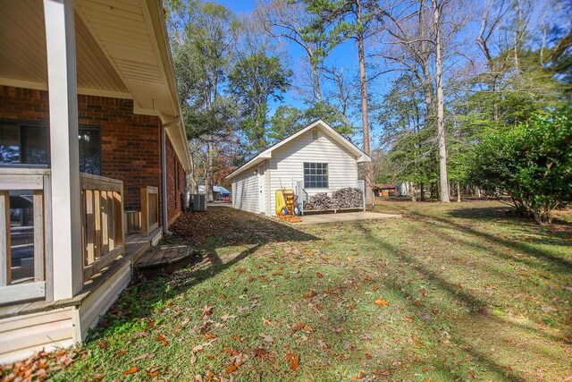 view of side of home with a yard