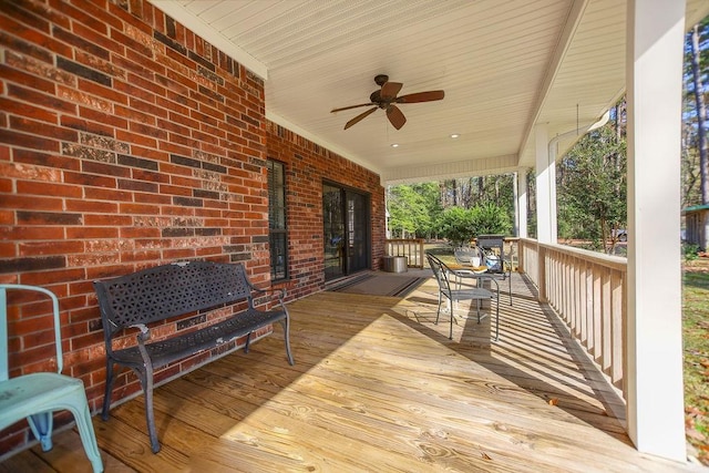 wooden terrace with ceiling fan and a porch