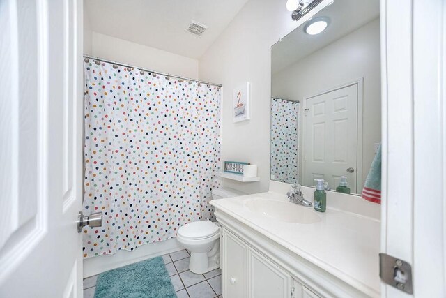 full bathroom featuring tile patterned flooring, vanity, shower / tub combo, and toilet