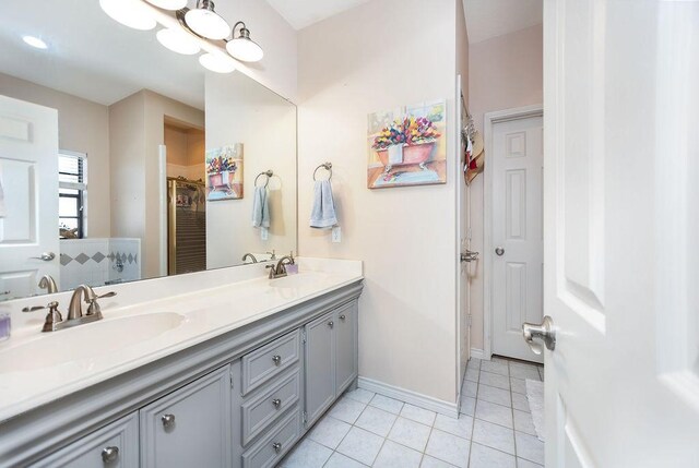 bathroom with vanity, tile patterned floors, and a shower with shower door